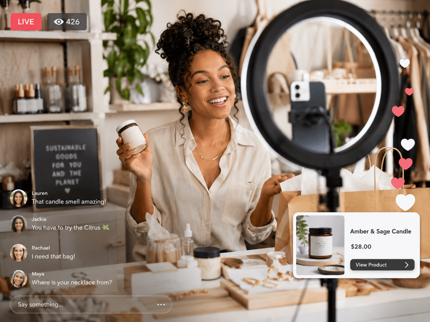 A boutique owner live-selling a scented candle to shoppers on camera